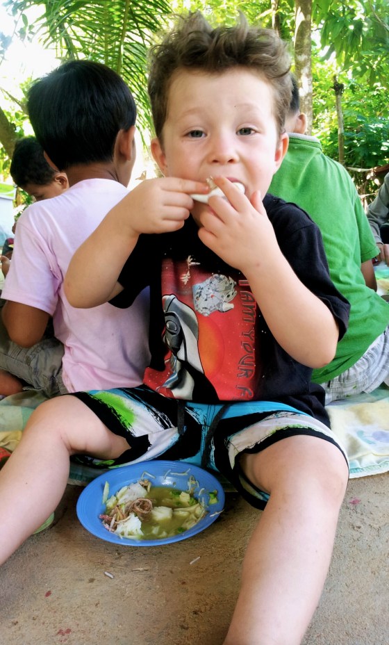 Beau having his fourth bowl of chicken soup on a school excursion to a nearby village